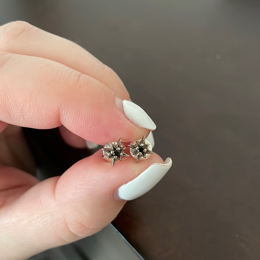 Silver star shaped studs with black stones
